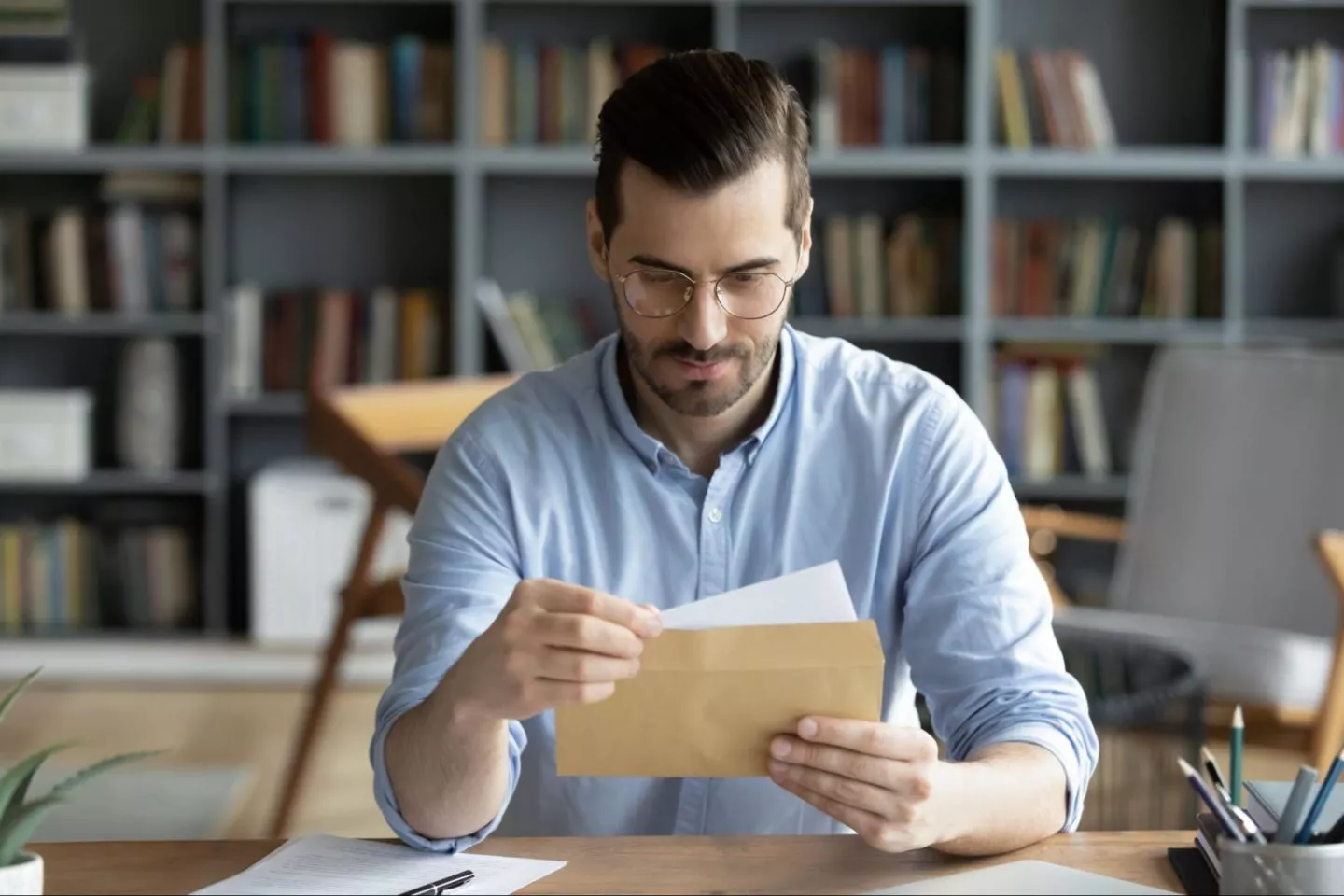 A business owner reviews bills and invoices as part of accounts payable/receivable accounting.