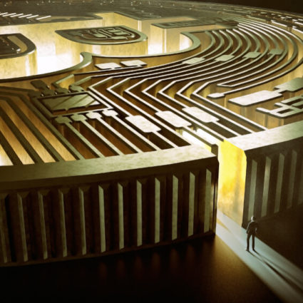 A man stands in front of a large gold maze designed to look like a Bitcoin.