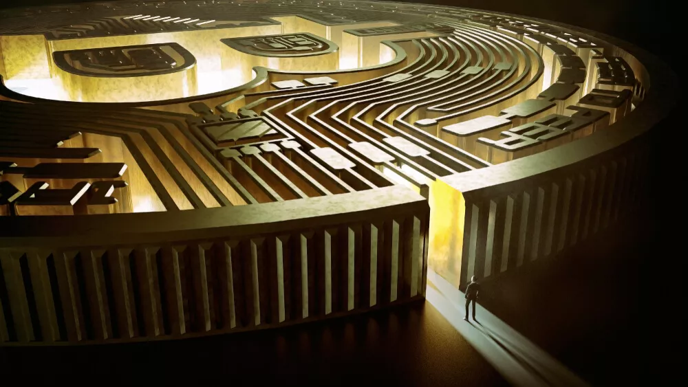 A man stands in front of a gold maze.